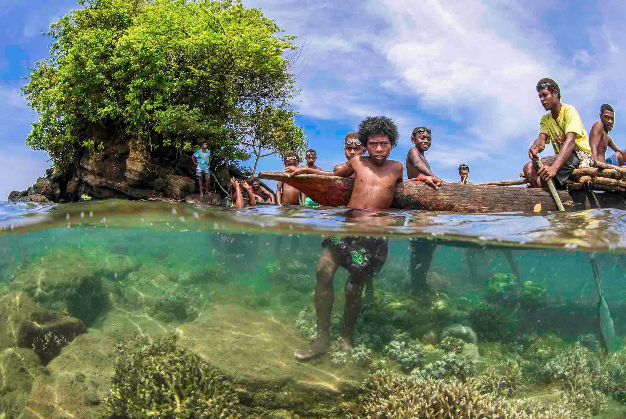 Local Papua New Guinea boys in front of Mangrove Trees