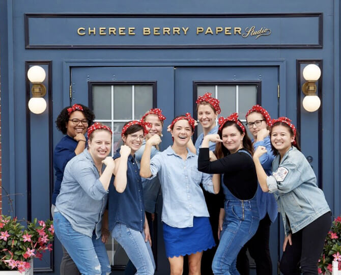 A group photo of Cheree Berry Paper & Design staffs with red polka dots headbands