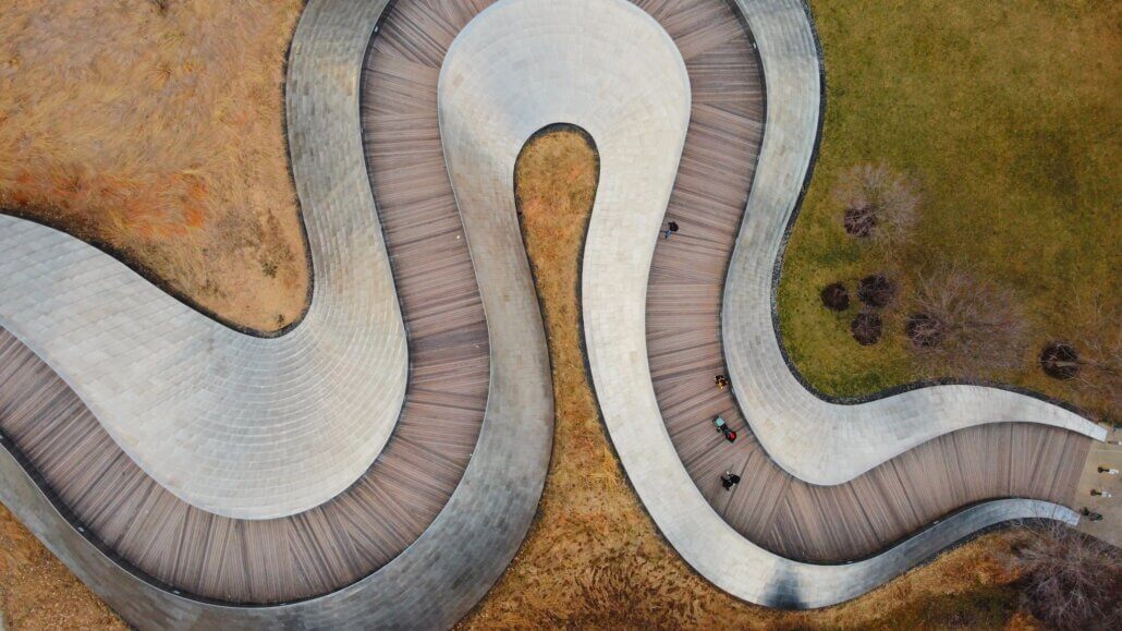 Aerial view of a curved walkway winding through a park.