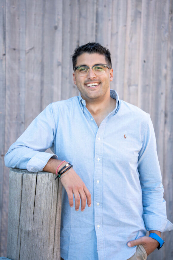 Chris Marine standing in front of a wood background